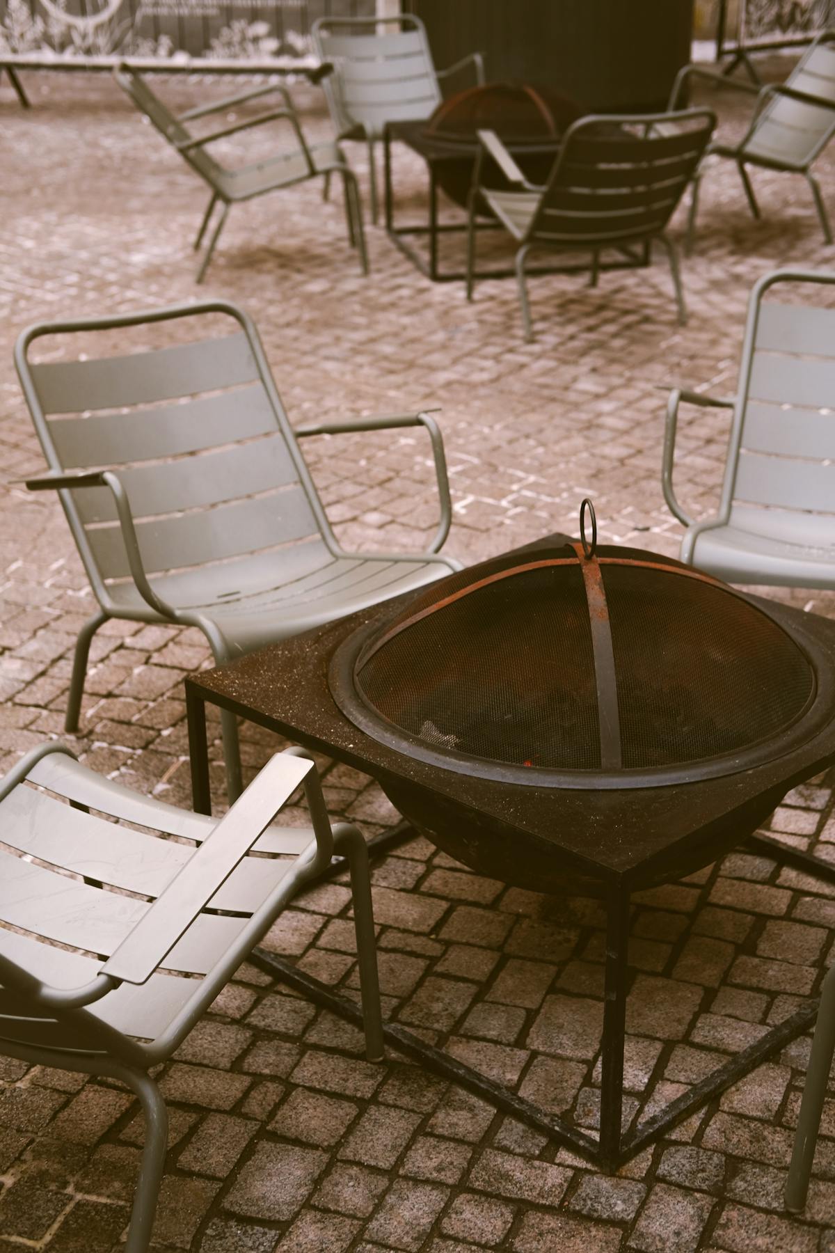 Custom welded steel fire pit with mesh cover